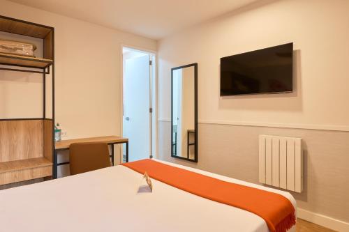 a hotel room with a bed and a television at Casa Andina Standard Ayacucho in Ayacucho