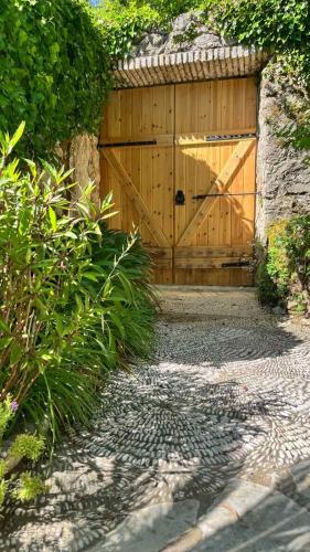 a wooden garage door with a gate in a yard at Villa Bakola in Sívros