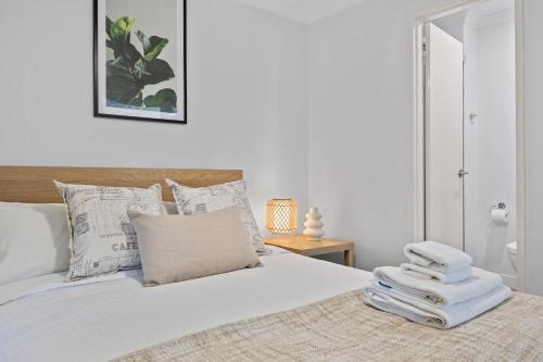 a bedroom with a bed with white sheets and pillows at Inviting 2BR Stay by the Sand at Rockingham in Rockingham