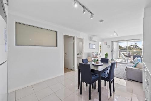 a dining room and living room with a table and chairs at Inviting 2BR Stay by the Sand at Rockingham in Rockingham