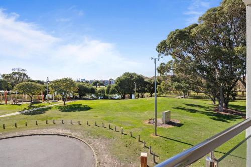 a view of a park from a balcony at Inviting 2BR Stay by the Sand at Rockingham in Rockingham