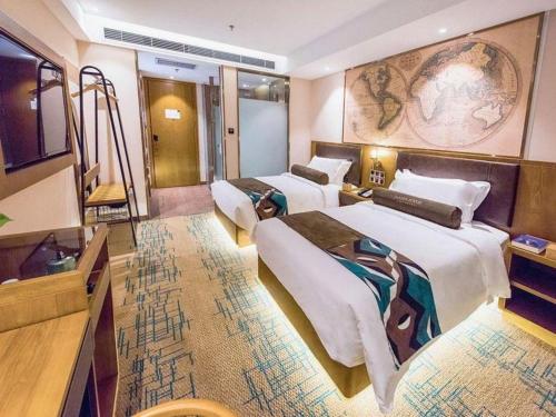 a hotel room with three beds and a television at James Joyce Coffetel Changchun People's Square in Changchun