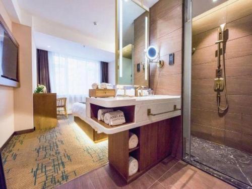 a bathroom with a sink and a shower at James Joyce Coffetel Changchun People's Square in Changchun