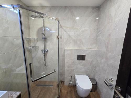 a bathroom with a shower and a toilet at Green Garden Apartments in Yerevan