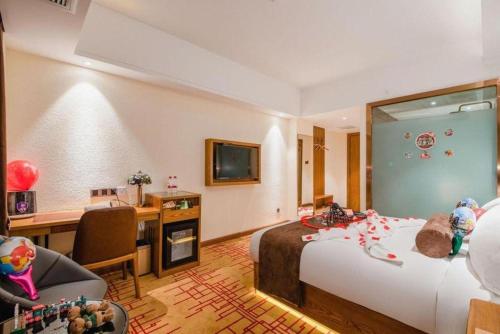 a hotel room with a bed and a desk and a room at James Joyce Coffetel Kunming Railway Station Huancheng Nan Road Metro Station in Kunming