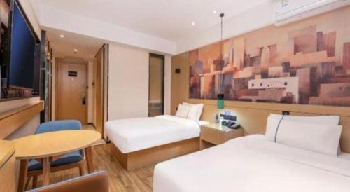 a hotel room with two beds and a table at City Comfort Inn Kunshan Development Zone Penglang Xinxing Middle Road in Suzhou