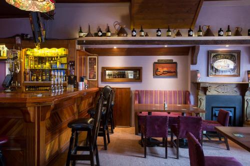a bar in a restaurant with tables and chairs at Mulcahys in Clonmel