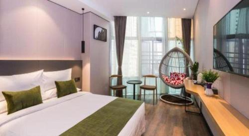 a hotel room with a large bed and a chair at Green Tree Inn Express Fuzhou Three Lanes and Seven Alleys Nanmendou Metro Station in Fuzhou