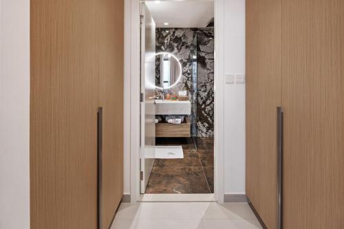 a bathroom with a sink and a mirror at Harbour Retreat Stunning Community Views in Dubai