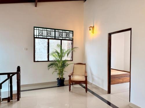 a room with a mirror and a chair and a window at House with Private Pool Perfect for Family Holiday in Mount Lavinia