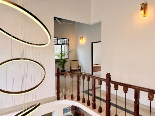 a hallway with a staircase with a round mirror at House with Private Pool Perfect for Family Holiday in Mount Lavinia