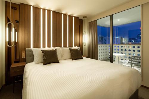 Un pat sau paturi într-o cameră la The OneFive Villa Fukuoka - Vacation STAY 33466v