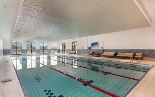 a large swimming pool in a building at Hidden Valley Resort in Wallan