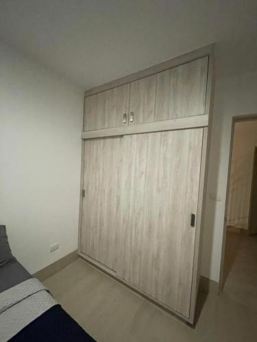 a large wooden garage door in a bedroom at Habitación y baño privado en lujoso residencial con alberca climatizada in Santa Gertrudis
