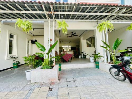 a porch of a house with potted plants at Tropical Mango House in Da Nang