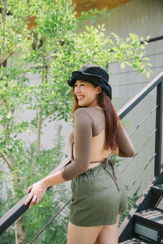 a young woman wearing a hat standing on a railing at The Tryst River Kwai in Ban Wang Yai (2)