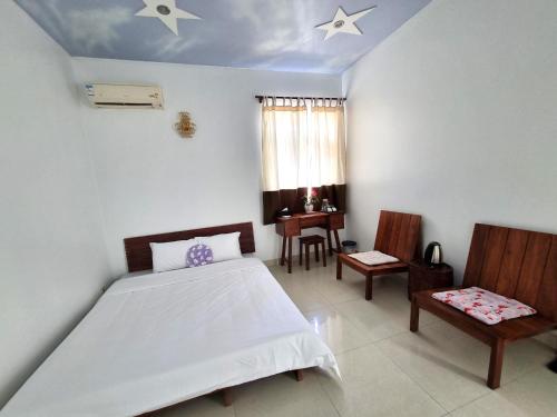 a bedroom with a bed and a table and chairs at Top Hill Halong in Ha Long