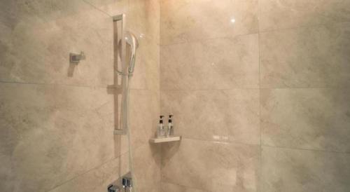 a bathroom with a shower with a glass door at Echarm Hotel Changsha Wuyi Square Xiangya Affiliated 1st Provincial Maternity and Child in Changsha