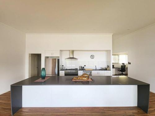 a large kitchen with a large island in the middle at Daintree Getaway - Private Oasis in Daintree