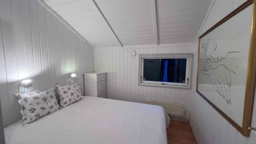 a small bedroom with a bed and a window at Super Cozy Holiday Home In Marielyst in Marielyst