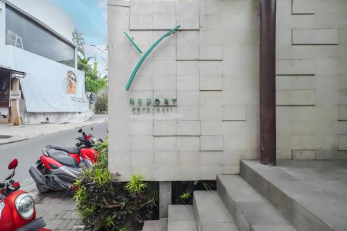 a group of motorcycles parked next to a building with a clock at Belvilla Y Resort Near Central Ubud in Ubud