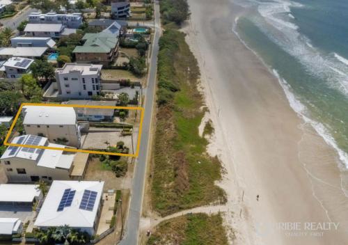 an aerial view of a beach with houses at Above The Dunes in Woorim