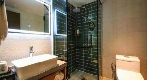 a bathroom with a sink and a shower and a toilet at GreenTree Inn Luoyang Henan University of Science and Technology in Luoyang
