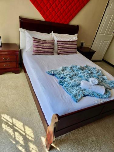 a bed with towels and pillows on it at SapzRes at Klerksdorp in Klerksdorp