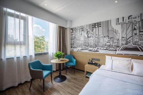 une chambre d'hôtel avec un lit et deux chaises dans l'établissement City Comfort Inn Ezhou Wuyue Plaza, à Ezhou