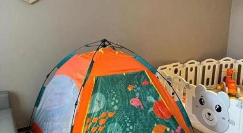 a colorful kite is sitting next to a crib at Borrman Hotel Korla Peacock River in Korla