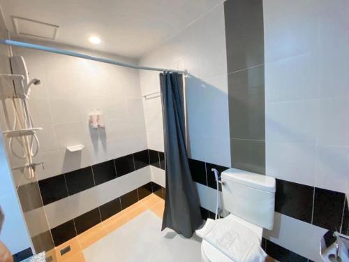 a bathroom with a shower and a toilet in a room at Siamtara Palace Hotel in Maha Sarakham