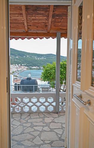 an open door to a balcony with a view at Ellovos, View from Above in Samos