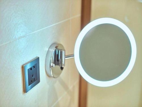a bathroom with a mirror next to a toilet at Lavande Hotel Changchun Gaoxin Jilin University in Changchun