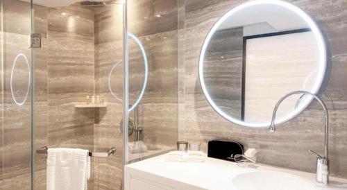a bathroom with a sink and a mirror at OASIS AVENUE-A GDH HOTEL in Hong Kong