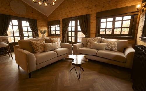 a living room with two couches and a table at St Hildas Complex in Hinderwell