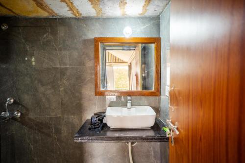 a bathroom with a sink and a mirror at Style Resort & Spa in Sām