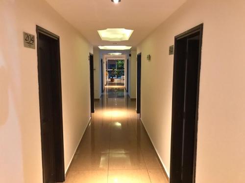 a hallway of a house with two doors open at Hotel Castellon Plaza Pereira in Pereira