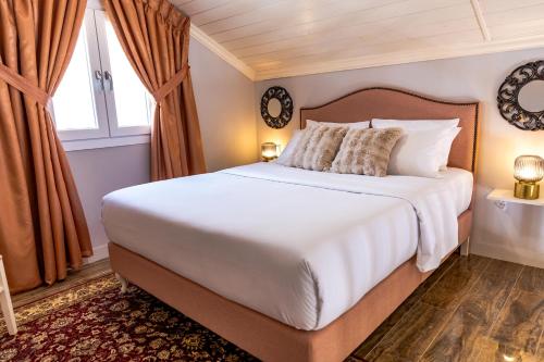 a bedroom with a large bed and a window at Nafsika Suites in Nea Moudania