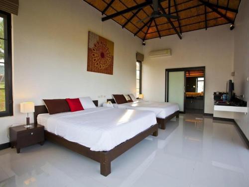a bedroom with two beds in a room at Chantara Valley Resort in Mu Si
