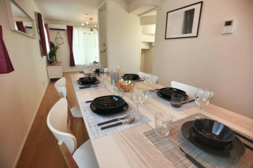 a dining room table with plates and glasses on it at SCD155 Private House for 9 with Rooftop in Ikebukuro, Direct Access to Tokyo's Core Commercial Districts in Tokyo