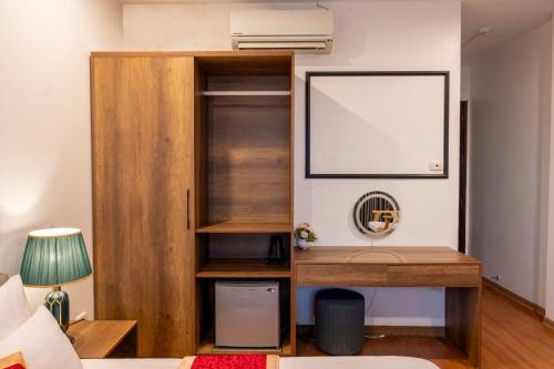 a room with a book shelf and a desk at Clover Hanoi Hotel - City Center in Hanoi