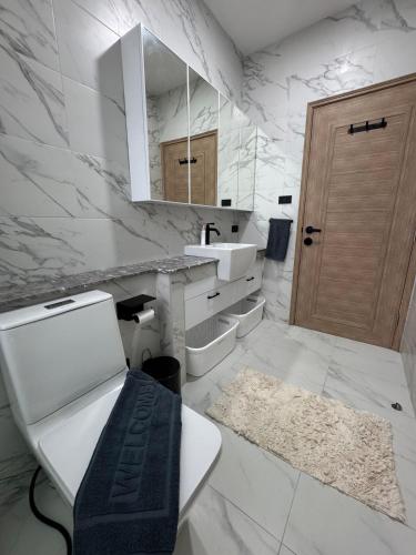a white bathroom with a toilet and a sink at Silver Palm Tree Villa - 2 Bedrooms Villa in Ao Nang Beach