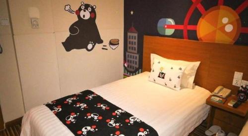 a bedroom with a bed with a black comforter with mickey mouse on at Jinjiang Inn Style Shenyang The Palace Huaiyuan Gate in Shenyang