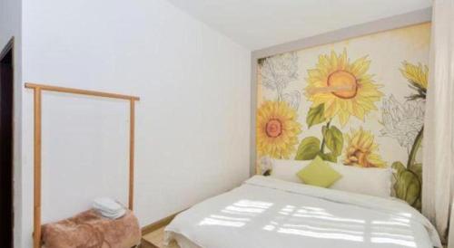 a bedroom with a bed with a flower mural on the wall at Dali Four Seasons Hostel in Dali Ancient Town