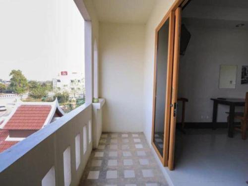 an open door to a room with a balcony at AmornSukhothai Hotel in Sukhothai