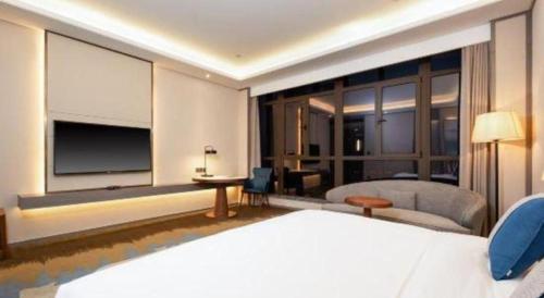 a hotel room with a bed and a large window at Rosedale Hotel Taicang in Taicang