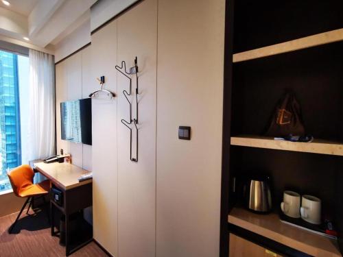 a room with a desk and a door with a deskablish at Ehotel in Hong Kong
