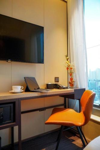 a room with a desk with a laptop and a chair at Ehotel in Hong Kong