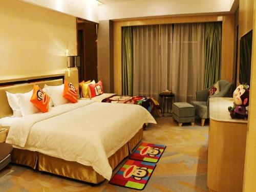a hotel room with a large bed and a chair at Shanghai Fuyue Hotel in Shanghai