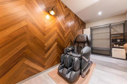 a chair in a room with a wooden wall at Cheongju Maryjane Hotel in Cheongju